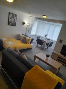 a living room with a couch and a bed at Flat 4 Corner House in Doncaster