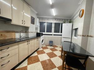 uma cozinha com um balcão, um frigorífico e um lavatório em CASA CARMEN 20 em Málaga