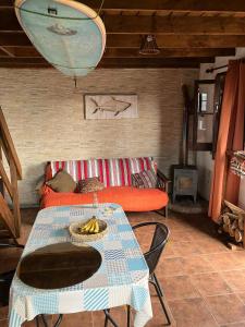 a living room with a table and a couch at Abuelo Andrés in Punta Del Diablo