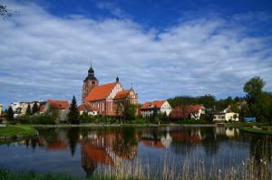 a large building next to a large body of water at Apartament Warmińska in Barczewo