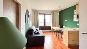 a living room with a couch and a kitchen with a table at Casa Alquife in Sierra Nevada