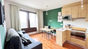 a living room with a blue couch and a kitchen at Casa Alquife in Sierra Nevada +17 photos