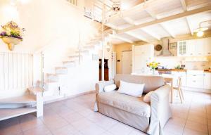 a living room with a couch and a staircase at Sweet home tuscany in Bientina