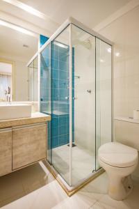 a bathroom with a glass shower and a toilet at Requinte à beira mar! Recarregue suas energias! in Angra dos Reis +28 photos