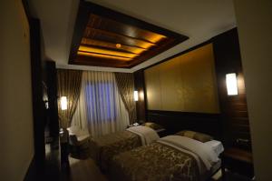 a hotel room with two beds and a ceiling at White Park Hotel in Sarıkamıs +34 photos