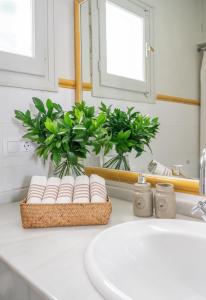 a bathroom sink with a basket of towels and a mirror at Villa en Marbella Artola&Friends in Marbella