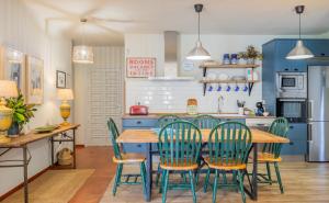 a kitchen with a wooden table and green chairs at Villa en Marbella Artola&Friends in Marbella