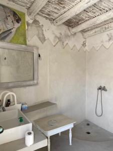 a bathroom with a sink and a toilet in it at Suite BELDI, La Maison des paons in Sidi Kaouki
