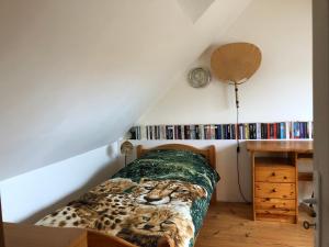 a bedroom with a bed with a lion on it at La Petite Maison arc-en-ciel in La Feuillie