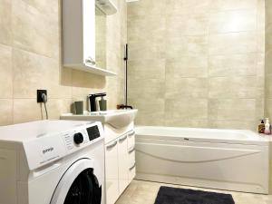 a bathroom with a washing machine and a sink at OASIS, Charming 1BD apartment with living room in Chişinău