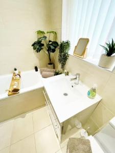 a bathroom with two sinks and potted plants at The perfect base to explore Liverpool and beyond in Liverpool