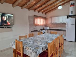 a kitchen with a table and chairs and a television at Colorina - El Nihuil in El Nihuil