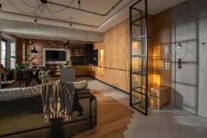 a living room with a couch and a kitchen at Industrial Apartment "I loft Opole" in Opole +40 photos