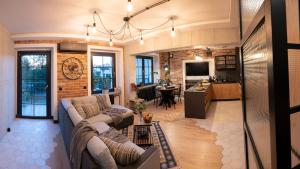 a living room and kitchen with a couch and a table at Industrial Apartment "I loft Opole" in Opole