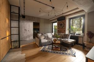 a living room with a couch and a table at Industrial Apartment "I loft Opole" in Opole