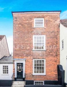 a brick building with white windows and a door at Beautiful Georgian townhouse in central Colchester in Colchester