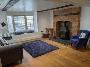 a living room with a couch and a fireplace at Beautiful Georgian townhouse in central Colchester in Colchester