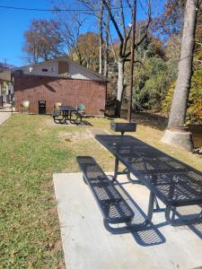 a picnic table and benches in a park at Economy Inn Sylva in Sylva