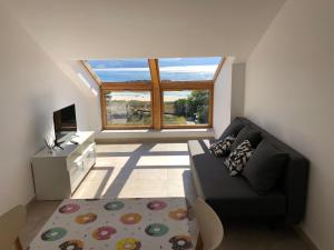 a living room with a couch and a large window at Apartamento Mar de Ardora Finisterre in Finisterre