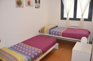 A bed or beds in a room at Apartamentos Jurramendi