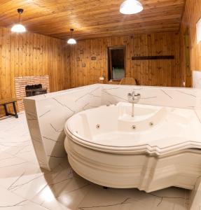 a bathroom with a bath tub and a sink at Chateau Tetri Bairagebi White Flags in Kisiskhevi