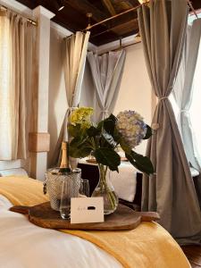 a table with a vase of flowers on a bed at Archaic Outhouse in Santee +9 photos