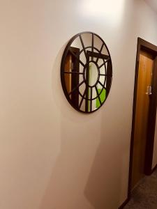 a circular mirror on a wall with a hallway at 'Woodbury' at stayBOOM in Lancaster