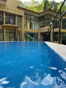 an empty swimming pool in front of a building at Private 5 Bedroom Home with Pool! in Tarcoles