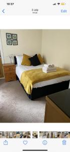 a bedroom with a bed with gold sheets and pillows at THE CARRIAGE HOUSE in Woodhorn