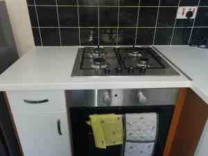 a kitchen with a stove top oven with a towel at London's Calling U! A Lovely 2 BedHome Sleeps 1-5! in London