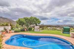 a swimming pool in the backyard of a house at Apricot Gardens Guesthouse in Gordonʼs Bay