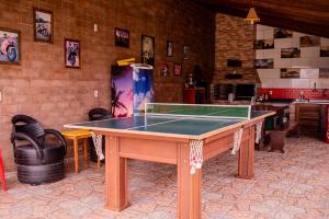 a ping pong table in the middle of a room at Pousada Chalés Beach - Praia do Rosa in Praia do Rosa