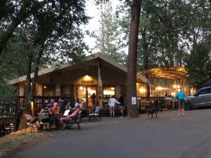 a group of people sitting outside of a restaurant at Yosemite Bug Rustic Mountain Resort in Midpines