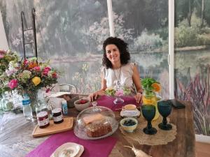 a woman sitting at a table with food at mi casa de buenos aires in Buenos Aires