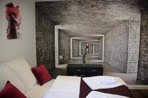 a room with a bed and a brick wall at Chalet Amour blanc in Les Houches
