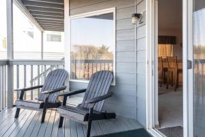 two chairs sitting on the porch of a house at Cozy 2 bedroom condo walking distance from the beach in Ocean Shores