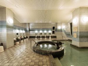 baño grande con bañera en el centro en KAMENOI HOTEL Awajishima, en Awaji