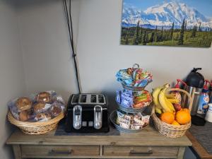 a table with baskets of food and fruit on it at Golden North Inn in Fairbanks