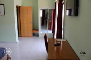 a dining room with a table and a mirror at Hotel Roterdão "Under New Management" in Praia