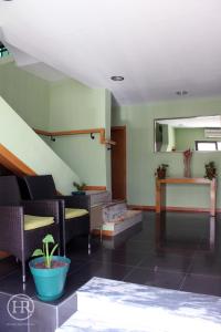 a living room with a couch and a staircase at Hotel Roterdão "Under New Management" in Praia