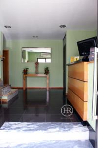 a living room with a desk and a mirror at Hotel Roterdão "Under New Management" in Praia