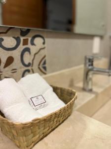 a basket of towels sitting on a counter next to a sink at Casona 1530 in Tequila