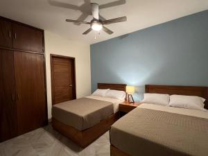 a bedroom with two beds and a ceiling fan at Casona 1530 in Tequila