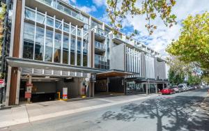 an office building on a street with a street at Mode Apartments Braddon ACT in Canberra