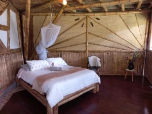 Postel nebo postele na pokoji v ubytování Ecohotel Soplo del Tambo