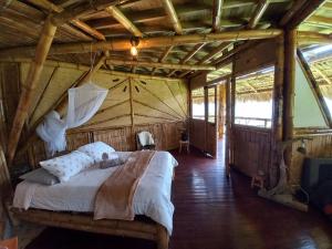 Postel nebo postele na pokoji v ubytování Ecohotel Soplo del Tambo