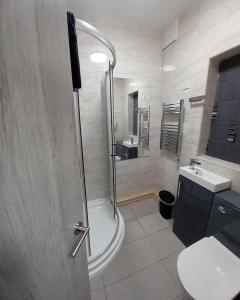 a bathroom with a shower and a toilet and a sink at Eighty Four in Birmingham