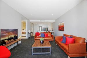 a living room with two couches and a coffee table at Pier 18 Kingston ACT in Kingston 