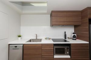 a kitchen with wooden cabinets and a sink at Waygoose Street Residence Kingston ACT in Kingston 