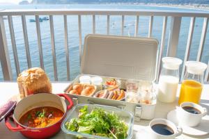 a lunch box with food on a table on a balcony at THE HARBOR TERRACE in Kotsubo